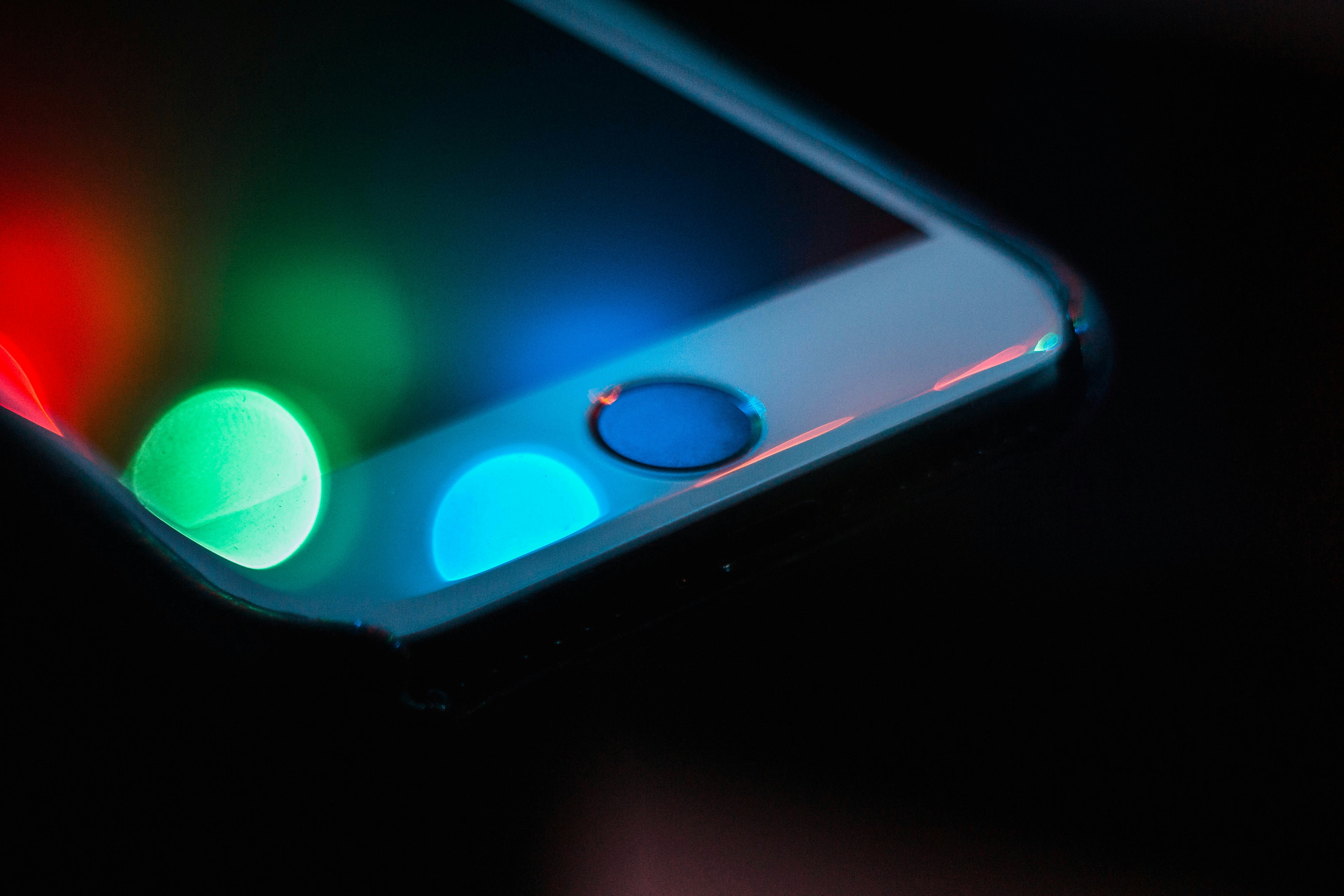 Край смартфона с AMOLED-экраном светится сочными красным, зелёным и синим на чёрном фоне